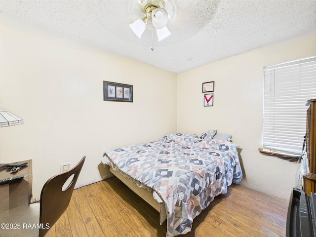 106 Cheticamp Dr, Lafayette, LA 70508 - bedroom with hardwood / wood-style floors, a textured ceiling, and a ceiling fan
