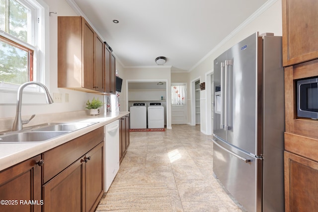 108 Trotter St, New Iberia, LA 70563 - kitchen featuring high quality fridge, washer and dryer, white dishwasher, a sink, and ornamental molding