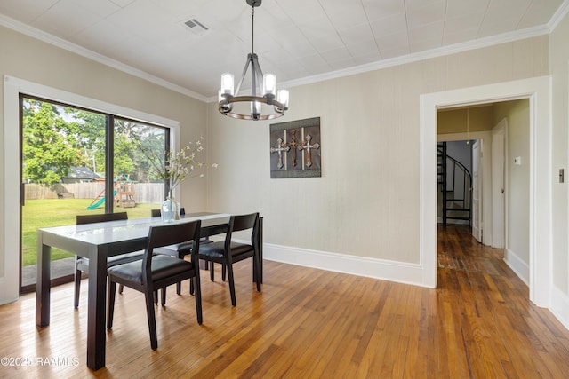 108 Trotter St, New Iberia, LA 70563 - dining area featuring a chandelier, baseboards, hardwood / wood-style floors, crown molding, and stairway