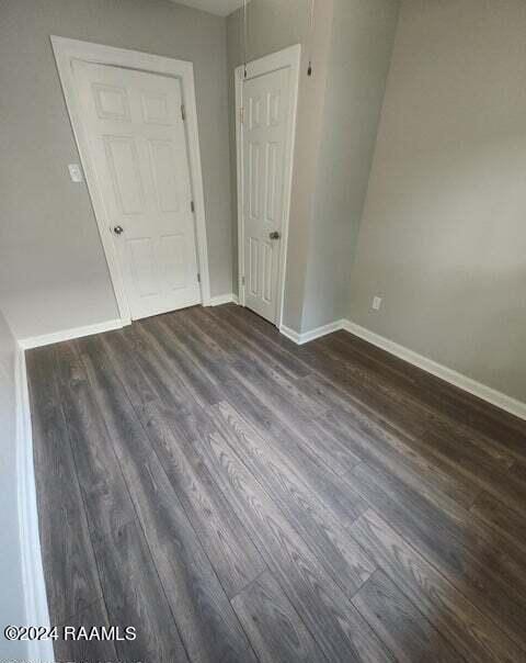 400 S Granger St, Erath, LA 70533 - empty room with dark wood-type flooring and baseboards