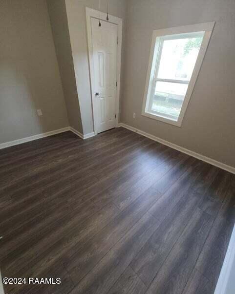 400 S Granger St, Erath, LA 70533 - empty room featuring baseboards and dark wood-style flooring