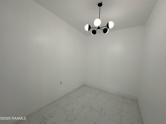 6033 Perry Ln, Lake Charles, LA 70605 - spare room with light marble finish floors, baseboards, and a chandelier