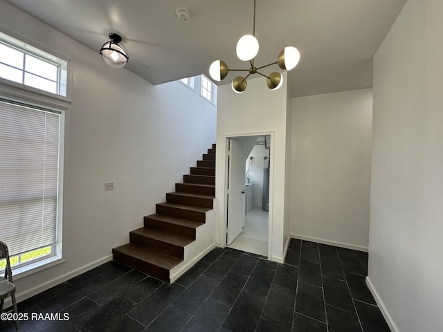 6033 Perry Ln, Lake Charles, LA 70605 - stairway featuring a chandelier, baseboards, and tile patterned floors
