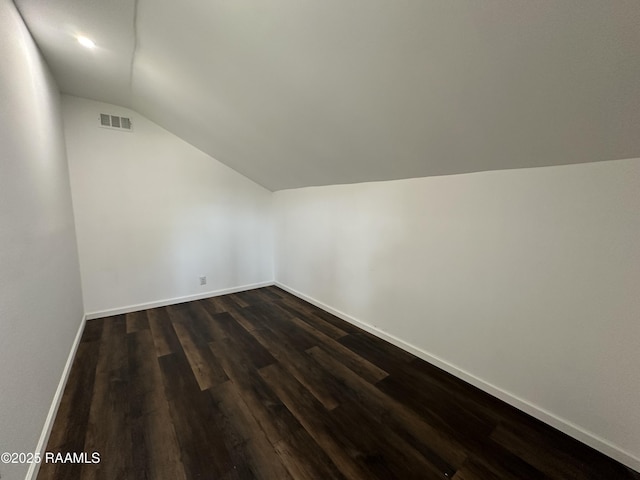 6033 Perry Ln, Lake Charles, LA 70605 - additional living space featuring lofted ceiling, dark wood-style floors, and baseboards