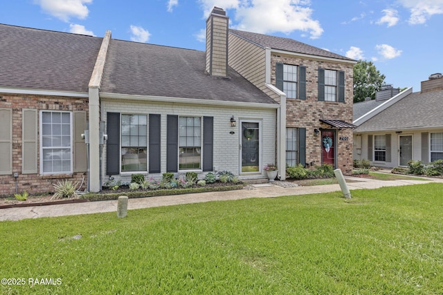 210 Long Plantation Blvd Unit C, Lafayette, LA 70508 - view of front facade with a front lawn, a chimney, roof with shingles, and brick siding