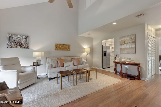 210 Long Plantation Blvd Unit C, Lafayette, LA 70508 - living room with light wood-type flooring, a ceiling fan, and a high ceiling