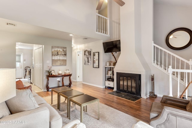 210 Long Plantation Blvd Unit C, Lafayette, LA 70508 - living room with wood finished floors, stairway, ceiling fan, a high ceiling, and recessed lighting