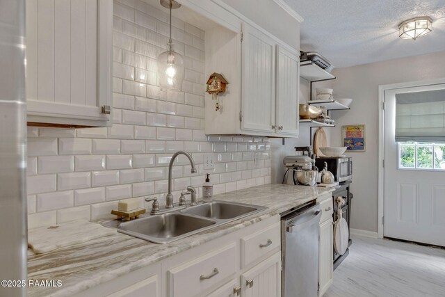 210 Long Plantation Blvd Unit C, Lafayette, LA 70508 - kitchen featuring appliances with stainless steel finishes, open shelves, tasteful backsplash, light countertops, and a textured ceiling