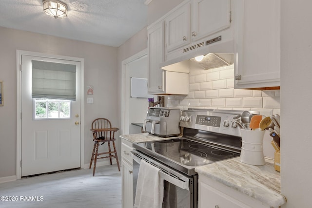 210 Long Plantation Blvd Unit C, Lafayette, LA 70508 - kitchen with stainless steel electric range oven, under cabinet range hood, decorative backsplash, white cabinetry, and a textured ceiling