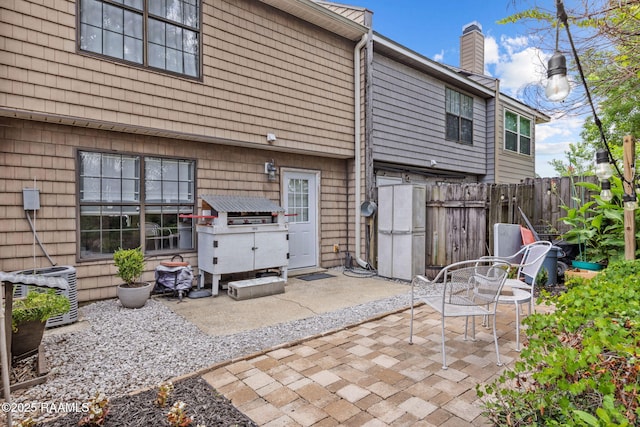 210 Long Plantation Blvd Unit C, Lafayette, LA 70508 - back of property featuring a chimney and a patio