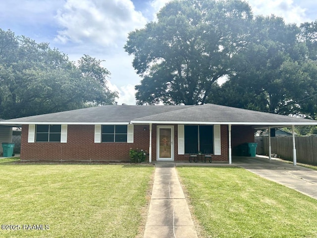 930 N 7th St, Eunice, LA 70535 - view of front of house with driveway, a carport, and brick siding