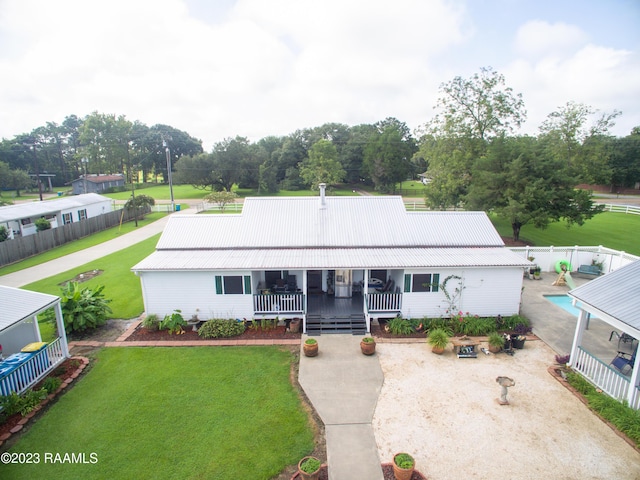 2944 Main Hwy, Breaux Bridge, LA 70517 - view of front of home with a porch, metal roof, and view of scattered trees