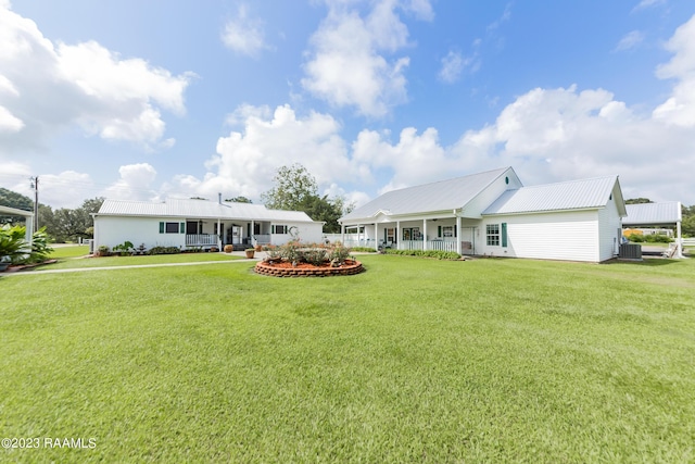 2944 Main Hwy, Breaux Bridge, LA 70517 - rear view of house featuring covered porch, central AC unit, and a lawn