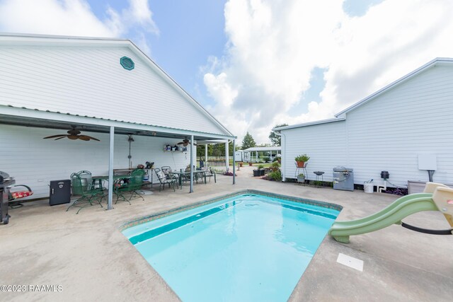 2944 Main Hwy, Breaux Bridge, LA 70517 - outdoor pool with a water slide, ceiling fan, a patio area, and outdoor dining space