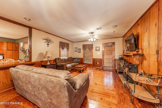 2944 Main Hwy, Breaux Bridge, LA 70517 - living area featuring wooden walls, crown molding, wainscoting, hardwood / wood-style floors, and a ceiling fan