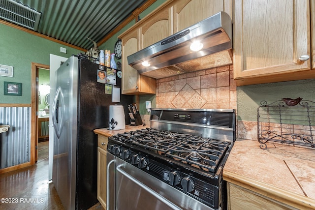 2944 Main Hwy, Breaux Bridge, LA 70517 - kitchen featuring stainless steel appliances, ventilation hood, tasteful backsplash, light countertops, and a textured wall