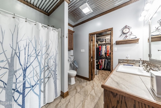 2944 Main Hwy, Breaux Bridge, LA 70517 - bathroom featuring vanity, toilet, ornamental molding, a walk in closet, and a shower with shower curtain