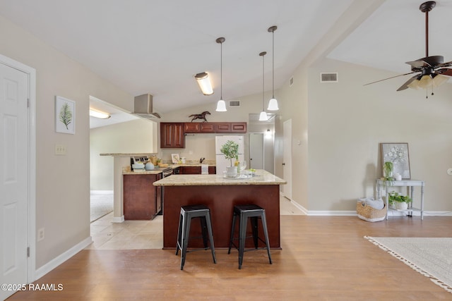 213 Marilyn Dr, Lafayette, LA 70503 - kitchen featuring light wood-type flooring, a ceiling fan, extractor fan, baseboards, and a center island