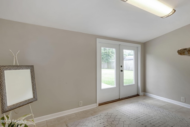 213 Marilyn Dr, Lafayette, LA 70503 - spare room with light tile patterned floors, french doors, and baseboards