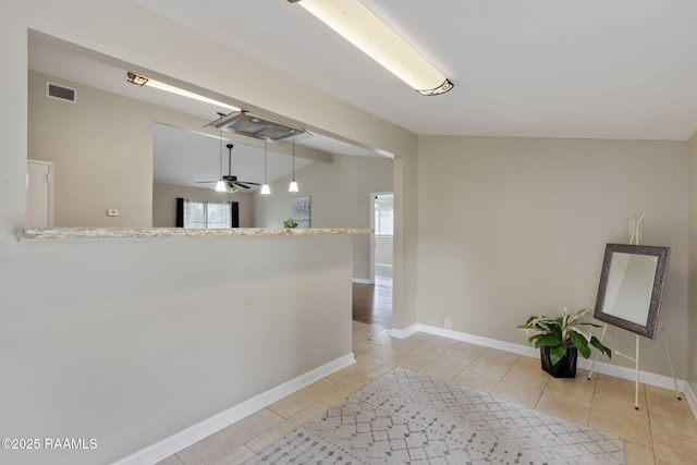 213 Marilyn Dr, Lafayette, LA 70503 - corridor featuring light tile patterned flooring, vaulted ceiling, and baseboards