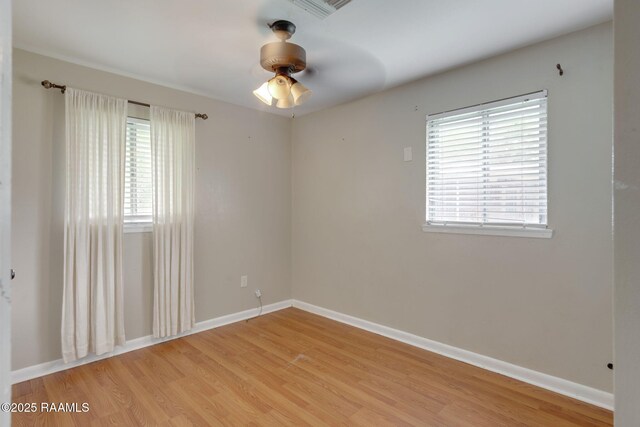 213 Marilyn Dr, Lafayette, LA 70503 - spare room featuring healthy amount of natural light, light wood-style floors, baseboards, and a ceiling fan