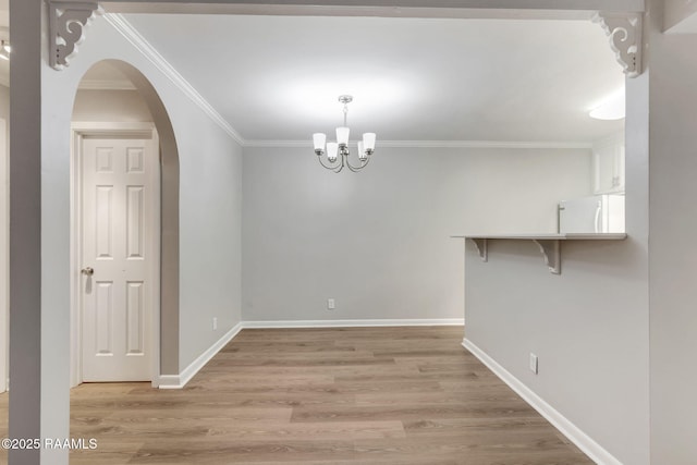 220 Doucet Rd Unit 230D, Lafayette, LA 70506 - empty room featuring light wood-style floors, crown molding, arched walkways, and a chandelier
