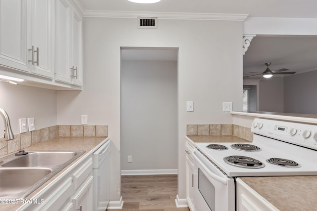 220 Doucet Rd Unit 230D, Lafayette, LA 70506 - kitchen featuring white appliances, light wood-style flooring, a ceiling fan, white cabinetry, and crown molding