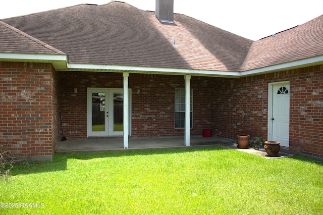 101 David St, Breaux Bridge, LA 70517 - rear view of property with french doors, a lawn, roof with shingles, brick siding, and a patio area