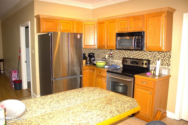 101 David St, Breaux Bridge, LA 70517 - kitchen featuring stainless steel appliances, crown molding, tasteful backsplash, and baseboards