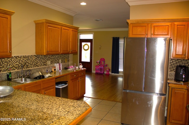 101 David St, Breaux Bridge, LA 70517 - kitchen featuring freestanding refrigerator, ornamental molding, light tile patterned floors, a sink, and tasteful backsplash
