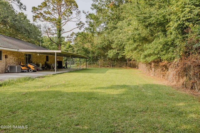 617 Sidney Dr, Breaux Bridge, LA 70517 - view of yard featuring central AC unit, a carport, and a patio