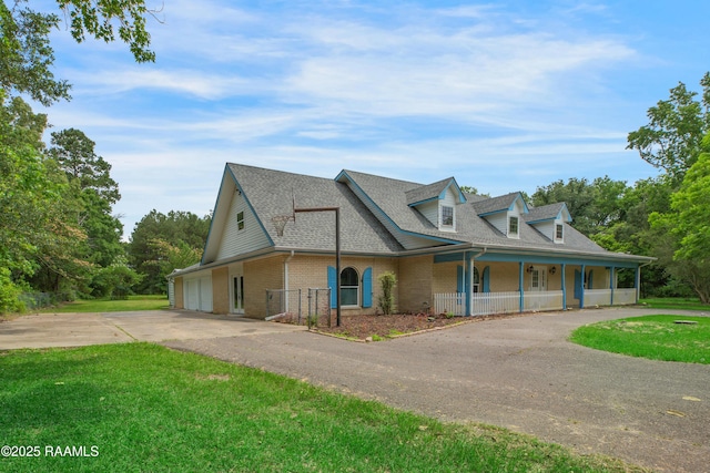 5811 Basile Eunice Hwy, Eunice, LA 70535 - farmhouse with asphalt driveway, a porch, brick siding, a front yard, and roof with shingles