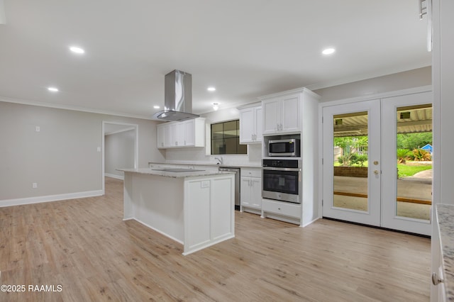 5811 Basile Eunice Hwy, Eunice, LA 70535 - kitchen with appliances with stainless steel finishes, french doors, island exhaust hood, ornamental molding, and white cabinetry
