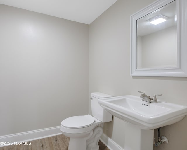 5811 Basile Eunice Hwy, Eunice, LA 70535 - half bathroom with baseboards, toilet, and wood finished floors