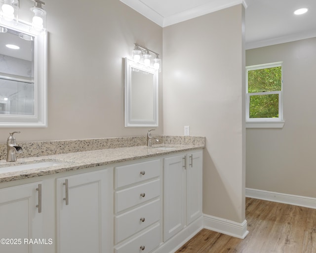 5811 Basile Eunice Hwy, Eunice, LA 70535 - bathroom with wood finished floors, double vanity, baseboards, and ornamental molding