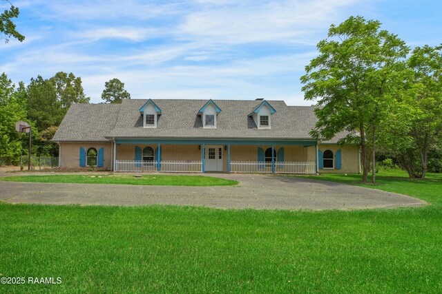 5811 Basile Eunice Hwy, Eunice, LA 70535 - cape cod house featuring covered porch, a front lawn, a shingled roof, and driveway