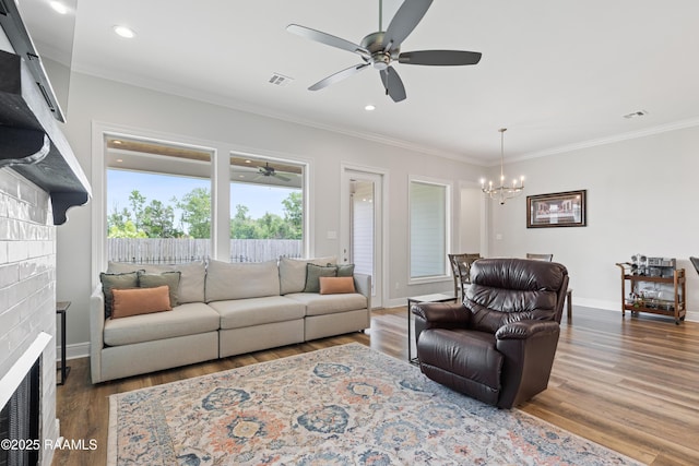 213 Octavia Dr, Scott, LA 70583 - living room with ceiling fan, a chandelier, wood finished floors, crown molding, and a fireplace