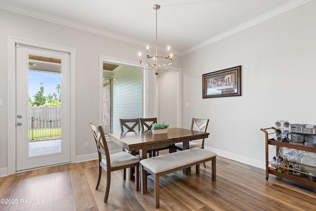 213 Octavia Dr, Scott, LA 70583 - dining room featuring crown molding, wood finished floors, a chandelier, and baseboards