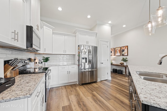 213 Octavia Dr, Scott, LA 70583 - kitchen with appliances with stainless steel finishes, a sink, ornamental molding, white cabinets, and light wood finished floors