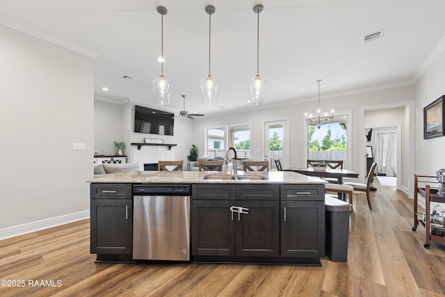 213 Octavia Dr, Scott, LA 70583 - kitchen with dishwasher, a sink, light wood-style floors, ornamental molding, and a kitchen island with sink