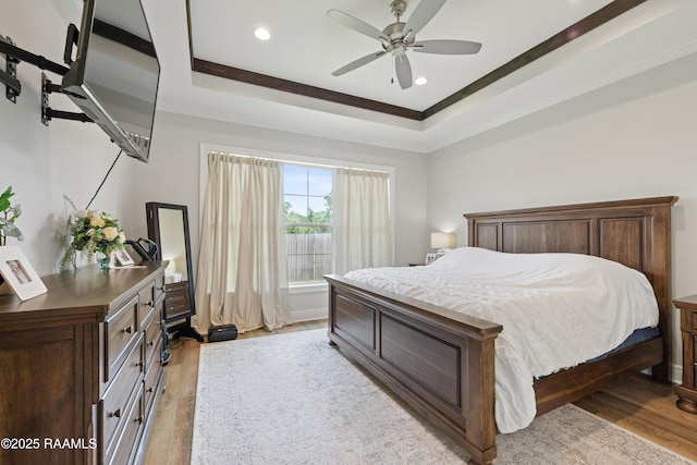 213 Octavia Dr, Scott, LA 70583 - bedroom with light wood-type flooring, ornamental molding, recessed lighting, a raised ceiling, and ceiling fan