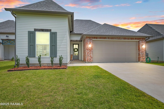 213 Octavia Dr, Scott, LA 70583 - view of front of property with concrete driveway, roof with shingles, an attached garage, and a lawn