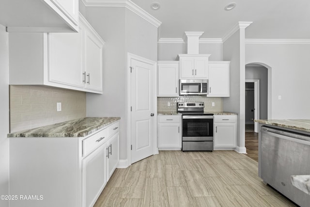147 Gable Crest Dr, Lafayette, LA 70507 - kitchen with stainless steel appliances, backsplash, ornamental molding, white cabinets, and recessed lighting