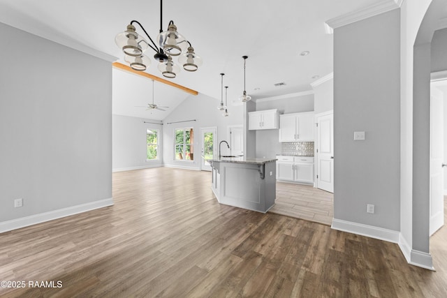 147 Gable Crest Dr, Lafayette, LA 70507 - kitchen with a chandelier, open floor plan, light wood-type flooring, a ceiling fan, and white cabinets