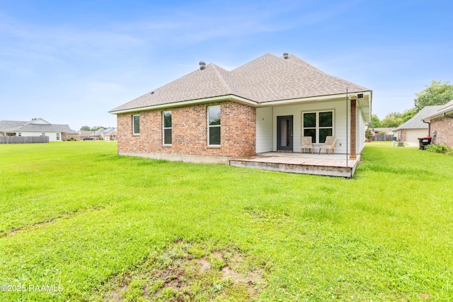 147 Gable Crest Dr, Lafayette, LA 70507 - back of house featuring roof with shingles, a yard, and brick siding