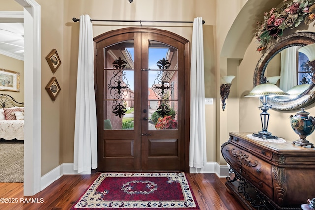 104 Baltimore Ln, Lafayette, LA 70506 - foyer entrance with dark wood-type flooring, ornamental molding, plenty of natural light, and arched walkways