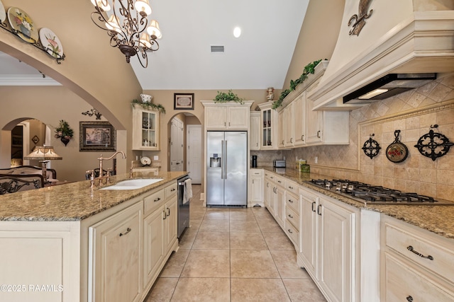 104 Baltimore Ln, Lafayette, LA 70506 - kitchen with appliances with stainless steel finishes, custom range hood, arched walkways, high vaulted ceiling, and tasteful backsplash