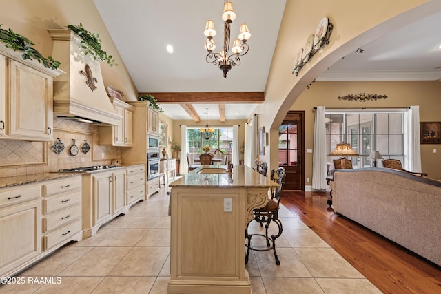 104 Baltimore Ln, Lafayette, LA 70506 - kitchen featuring a chandelier, stainless steel appliances, cream cabinets, arched walkways, and recessed lighting
