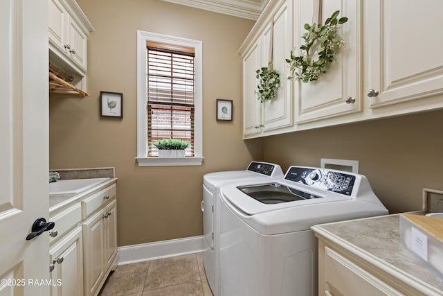 104 Baltimore Ln, Lafayette, LA 70506 - laundry area with independent washer and dryer, cabinet space, and light tile patterned floors