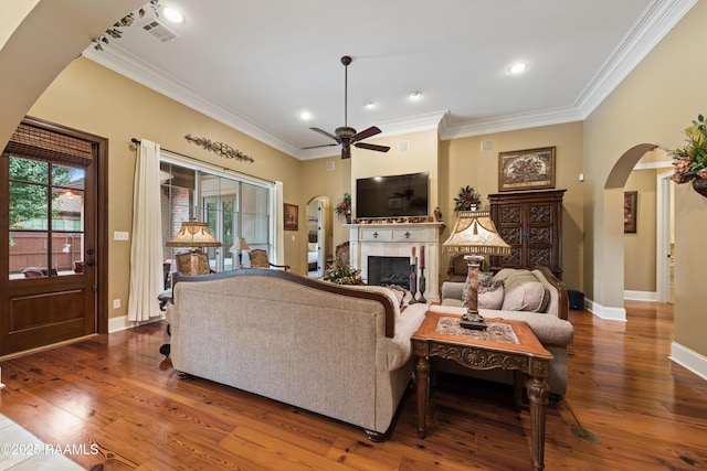 104 Baltimore Ln, Lafayette, LA 70506 - living room with arched walkways, ornamental molding, a fireplace, a ceiling fan, and hardwood / wood-style flooring